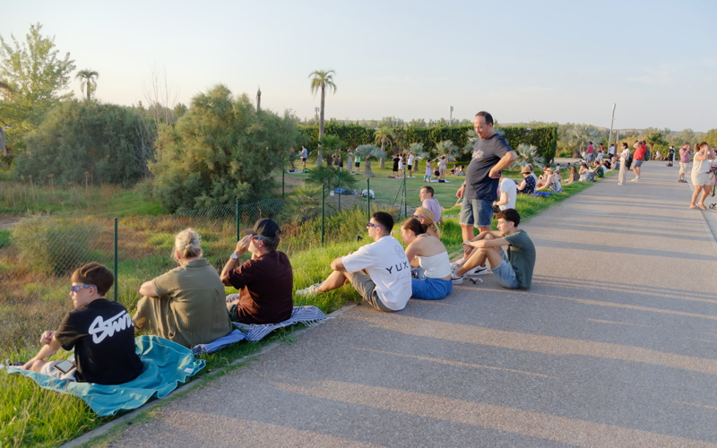 6 - A group of people gathering outdoors awaiting the solar eclipse astronomical event in Spain in 2026